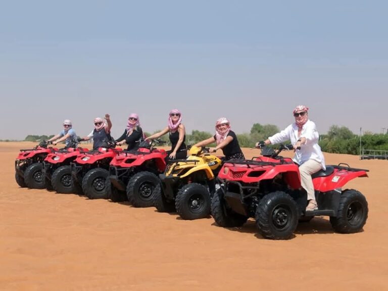 Group of guests lined up on quad bikes in the desert