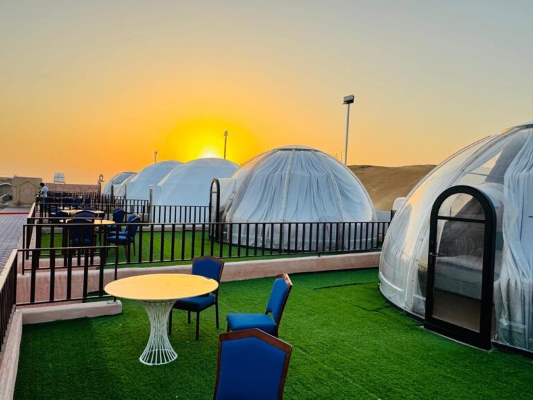 Overnight dome tents at the desert camp at sunset
