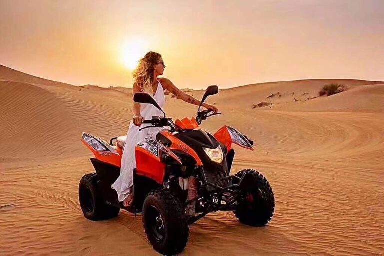 Guest riding a quad bike at sunset in the Dubai desert