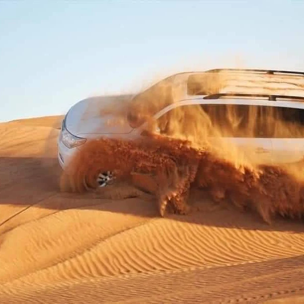 4x4 dune bashing over the red dunes on the evening desert safari